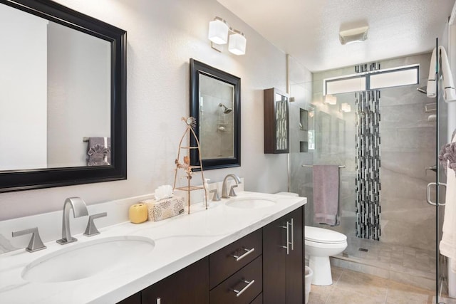 bathroom featuring walk in shower, tile patterned flooring, a textured ceiling, toilet, and vanity