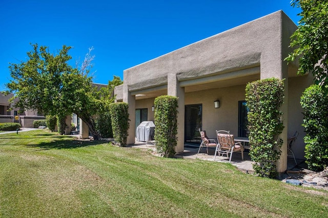 rear view of property with a yard