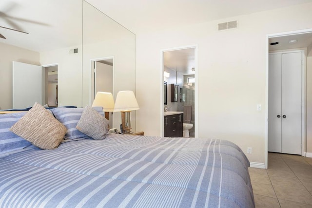 bedroom featuring light tile patterned floors, connected bathroom, and ceiling fan