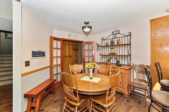 dining area featuring dark hardwood / wood-style flooring and french doors