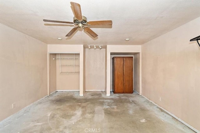 unfurnished bedroom with ceiling fan, concrete floors, and a closet