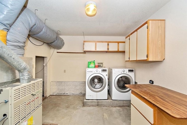 laundry room featuring washing machine and dryer and cabinets