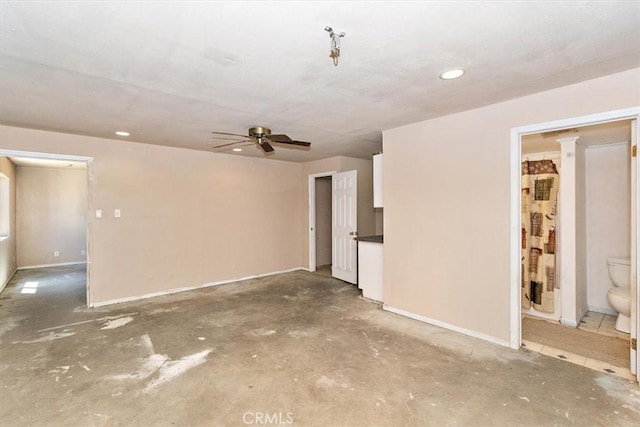 empty room featuring ceiling fan and concrete floors