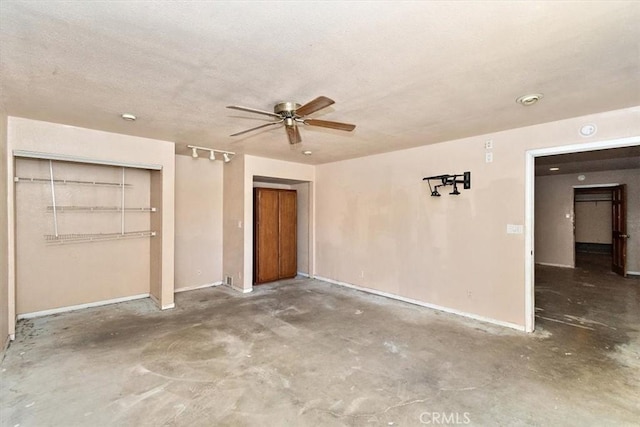 unfurnished bedroom featuring ceiling fan, concrete flooring, and a closet