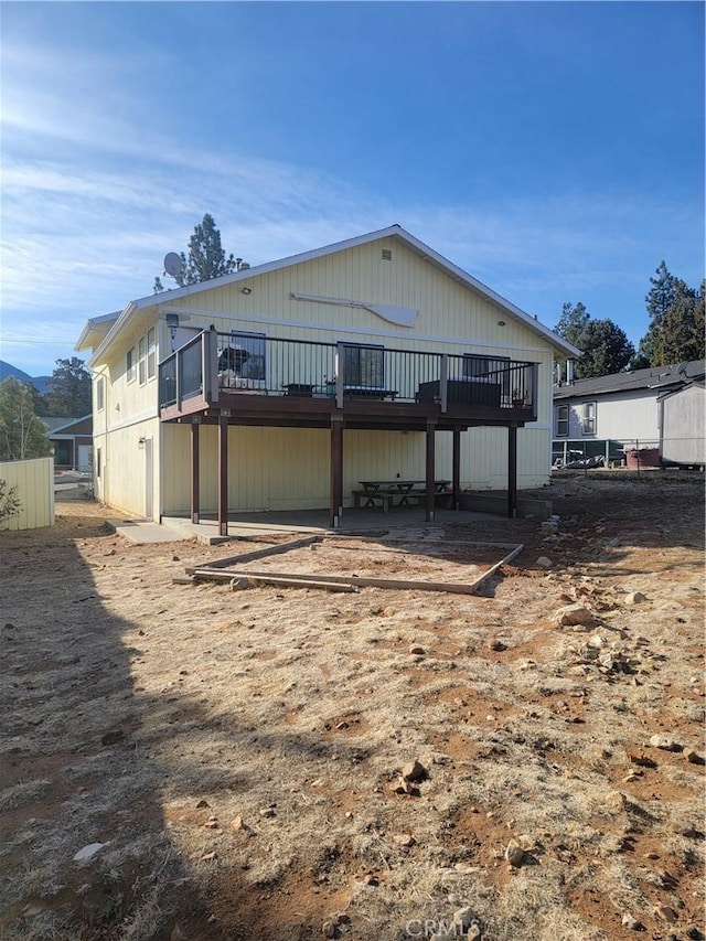 back of property with a wooden deck