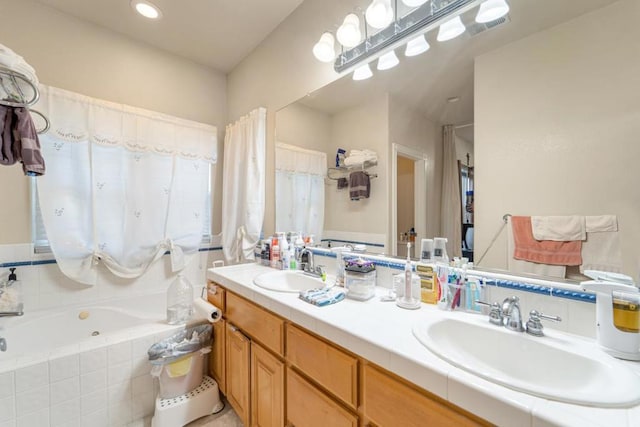 bathroom featuring tiled bath and vanity