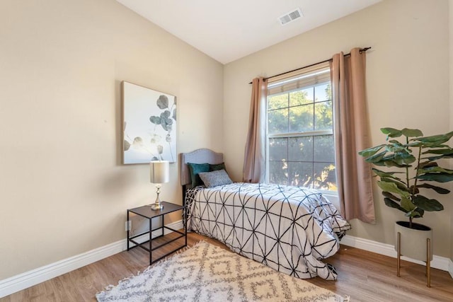 bedroom with hardwood / wood-style flooring