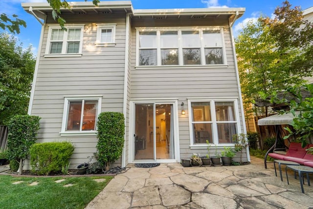 rear view of house featuring a patio