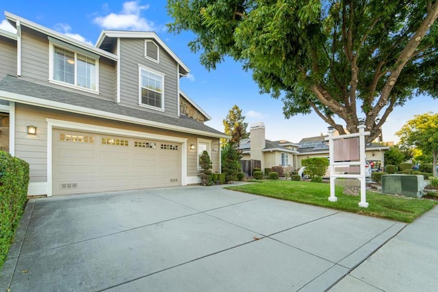 view of front of house featuring a front yard and a garage