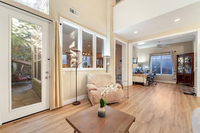 living room featuring ceiling fan and light hardwood / wood-style flooring