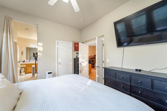 bedroom featuring ceiling fan, light wood-type flooring, and ensuite bathroom