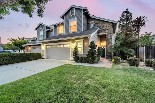 view of front facade with a yard and a garage