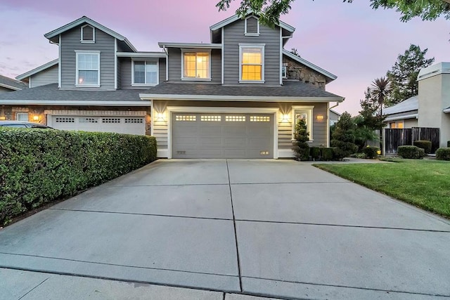 view of front of property featuring a lawn and a garage