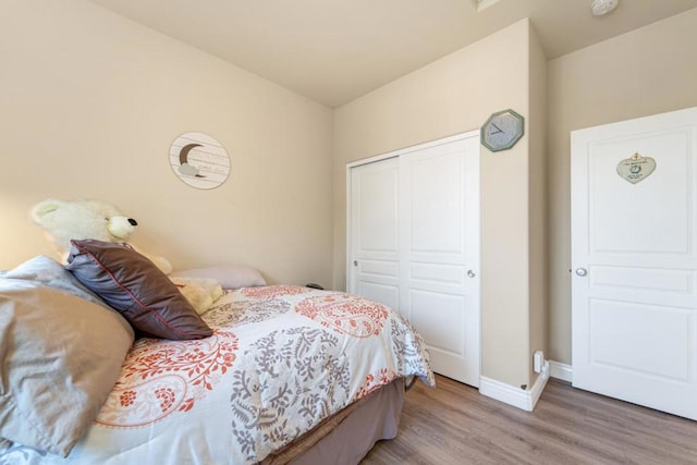 bedroom with a closet and hardwood / wood-style floors