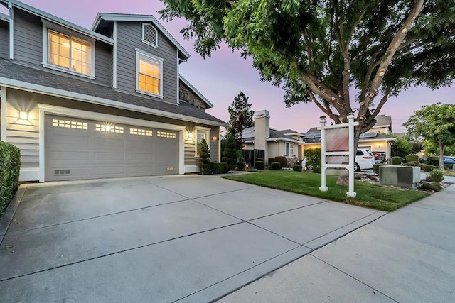 view of front of house with a lawn and a garage