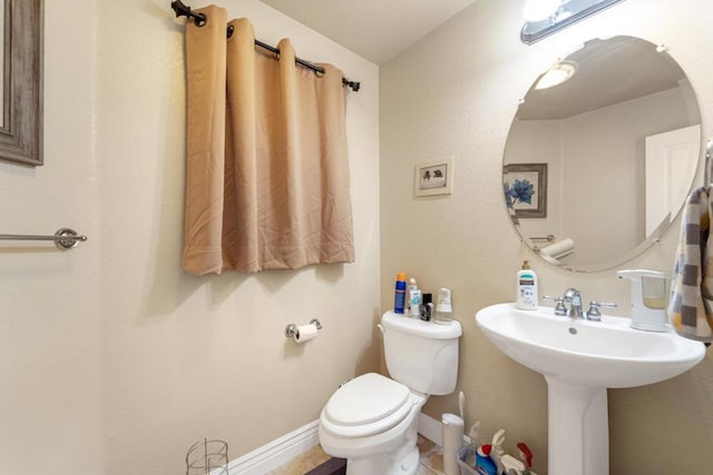 bathroom featuring tile patterned flooring and toilet