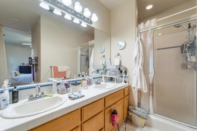 bathroom featuring vanity and an enclosed shower