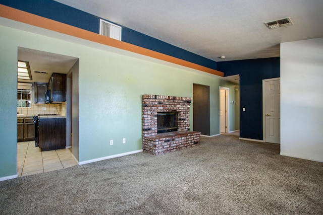 unfurnished living room featuring light carpet and a fireplace