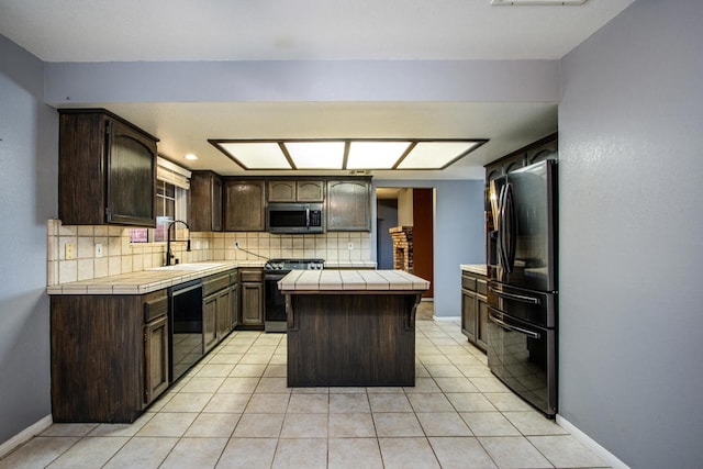 kitchen with light tile patterned flooring, dark brown cabinetry, tile counters, tasteful backsplash, and black appliances