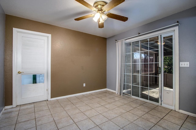 spare room featuring ceiling fan and light tile patterned flooring