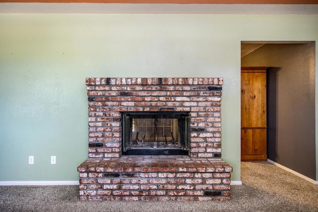 interior details with a fireplace and carpet flooring