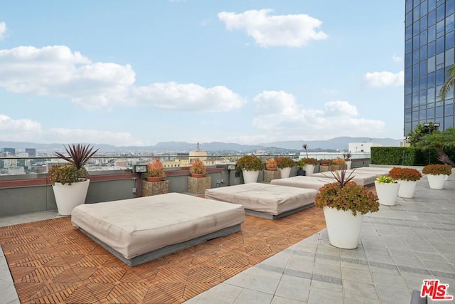 view of patio featuring a mountain view and a balcony