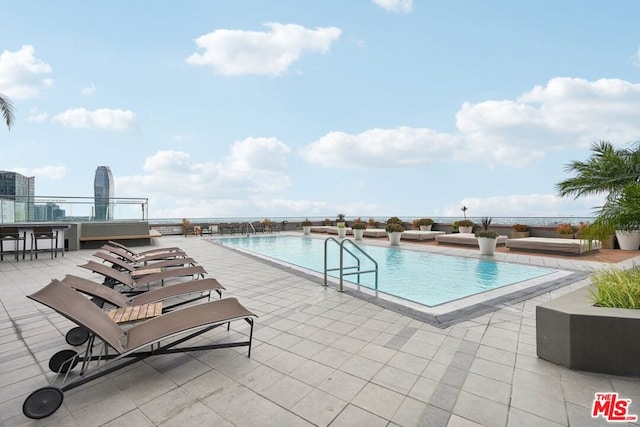 view of swimming pool featuring a patio area