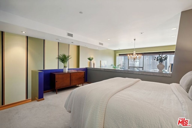 bedroom with an inviting chandelier and carpet