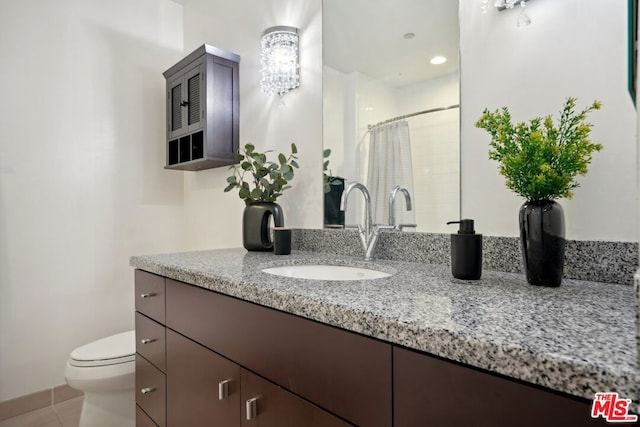 bathroom featuring curtained shower, tile patterned floors, toilet, and vanity