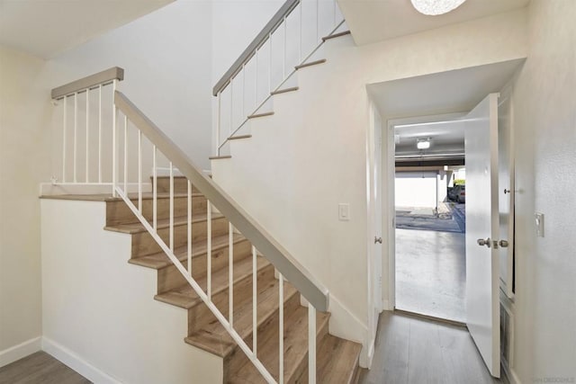 staircase with wood-type flooring