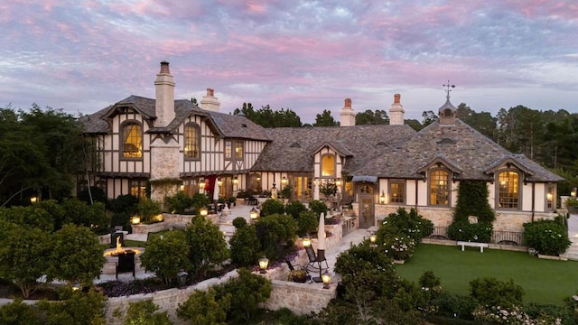 view of front of property featuring a patio area and a lawn