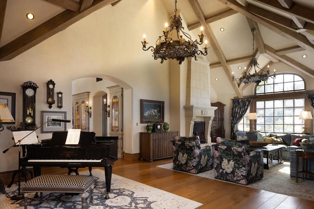 miscellaneous room with a large fireplace, high vaulted ceiling, wood-type flooring, and beamed ceiling