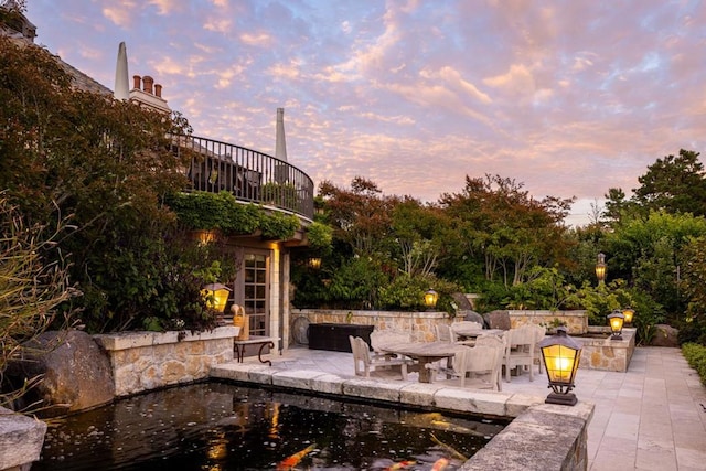 view of patio terrace at dusk