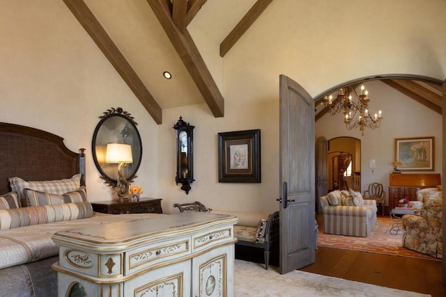 interior space featuring high vaulted ceiling, beamed ceiling, light hardwood / wood-style flooring, and a chandelier