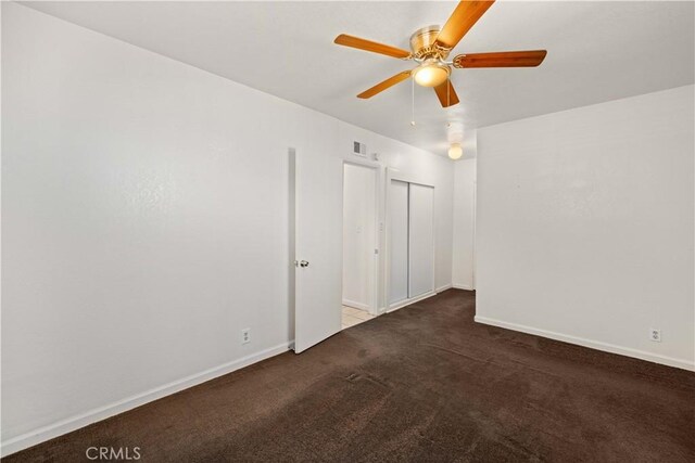 interior space with visible vents, carpet, a ceiling fan, and baseboards