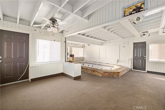 interior space featuring ceiling fan and beamed ceiling