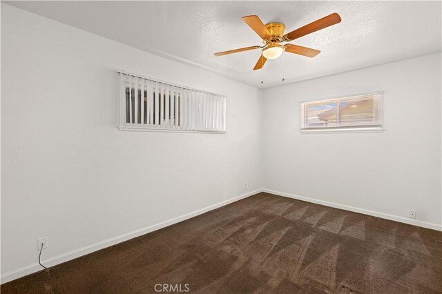 spare room with carpet floors and ceiling fan