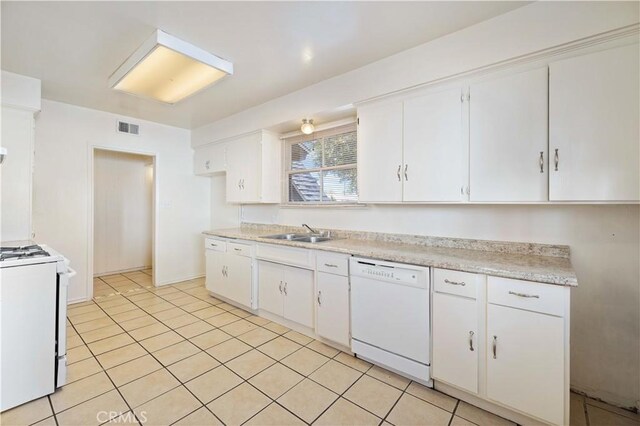 kitchen with white cabinets, white appliances, and light tile patterned floors