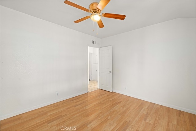 spare room with ceiling fan and light wood-type flooring