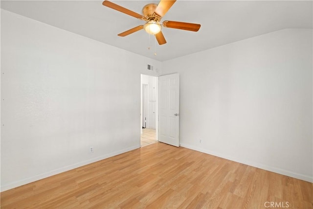 unfurnished room with light wood-style floors, baseboards, visible vents, and ceiling fan