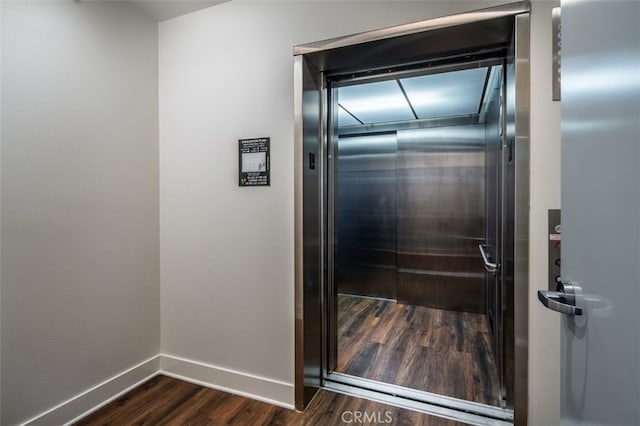 details featuring wood-type flooring and elevator