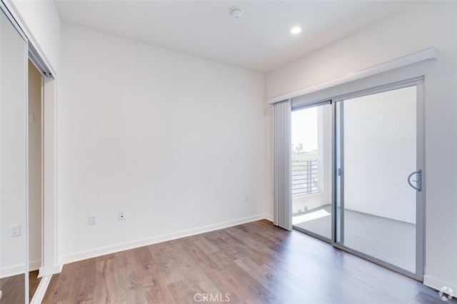 spare room with wood-type flooring