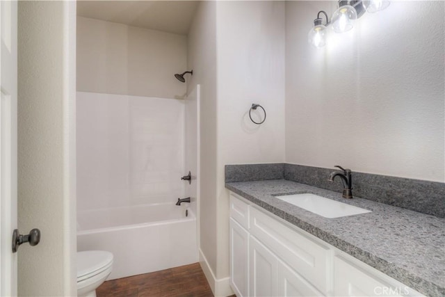 full bathroom with toilet, hardwood / wood-style floors, bathtub / shower combination, and vanity