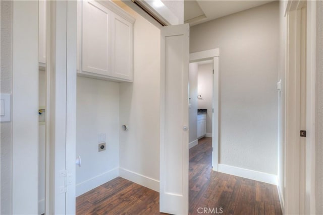 laundry area featuring cabinets, dark hardwood / wood-style floors, and electric dryer hookup