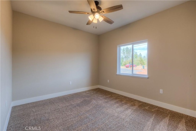 spare room with carpet floors and ceiling fan