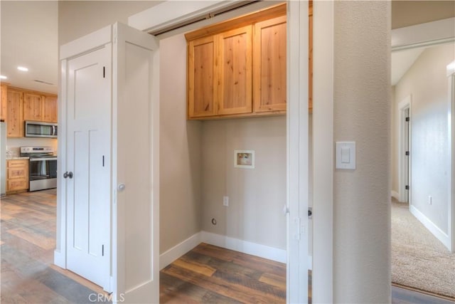 laundry room featuring dark wood-type flooring, cabinets, and washer hookup