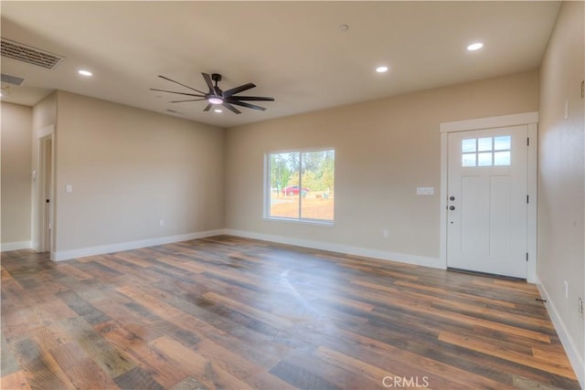 foyer entrance with ceiling fan, dark wood-type flooring, and plenty of natural light