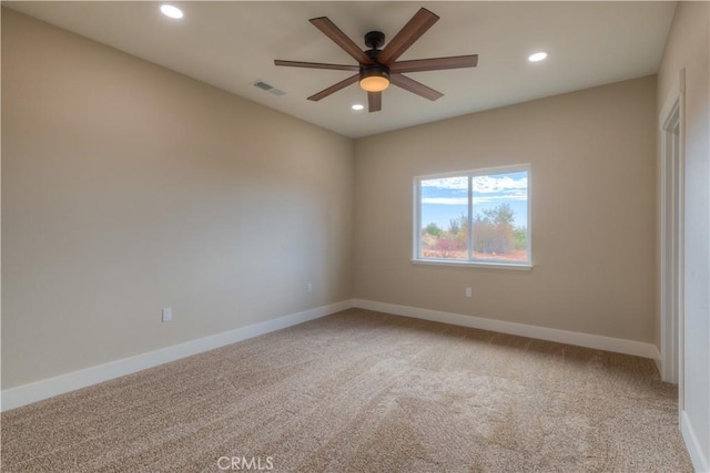 carpeted empty room featuring ceiling fan