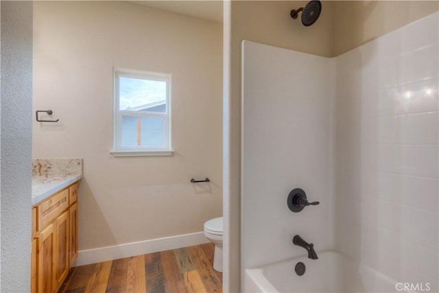 full bathroom with toilet, vanity, hardwood / wood-style floors, and tub / shower combination