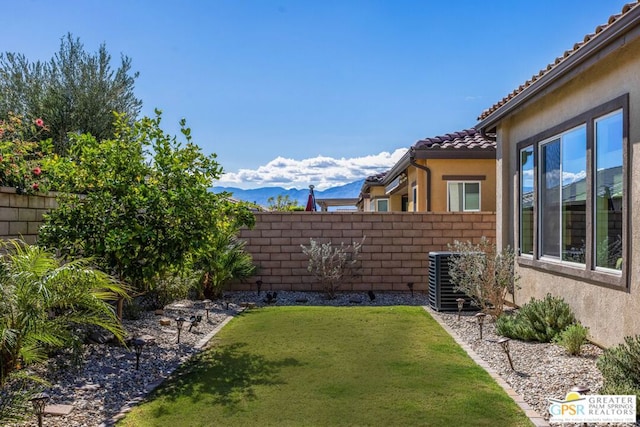 view of yard featuring central air condition unit and a mountain view